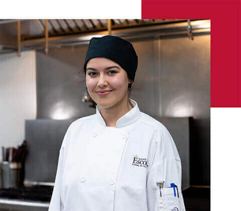 Culinary student in uniform smiling for a photo