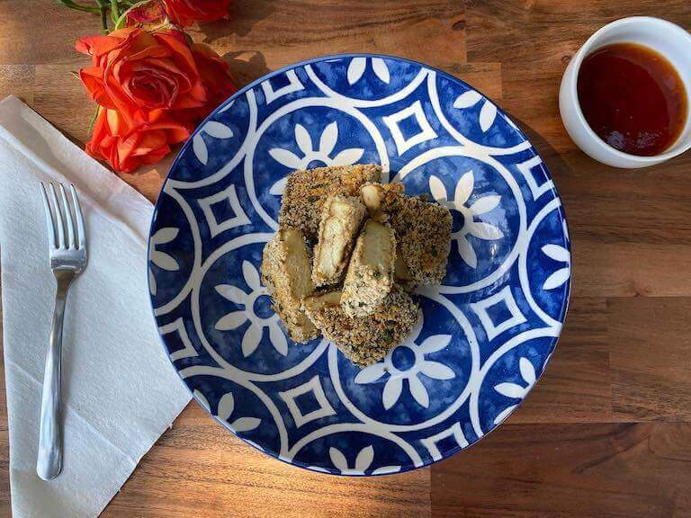 Encrusted tofu on a blue and white plate