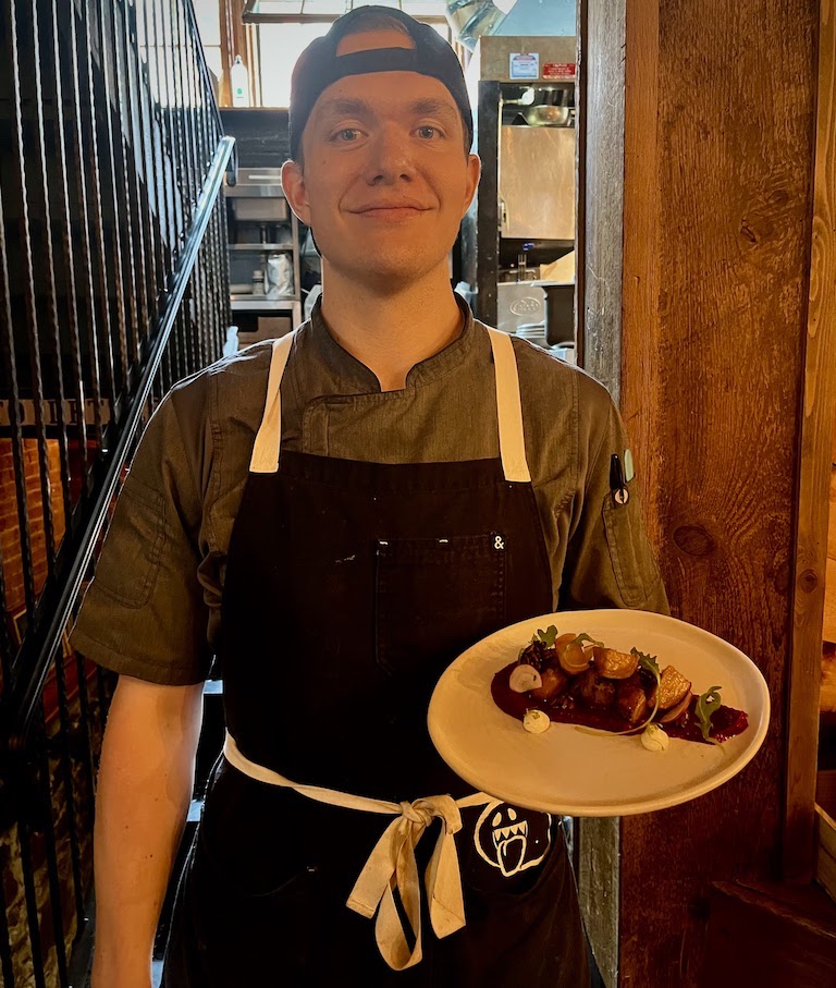 Jackson holding his Beet Salad on a white plate