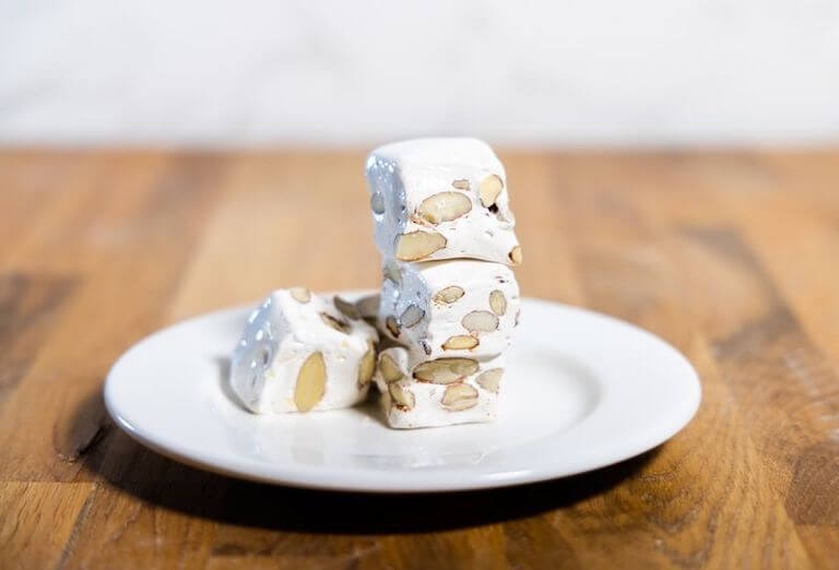 Nougat cut into four squares stacked on eachother