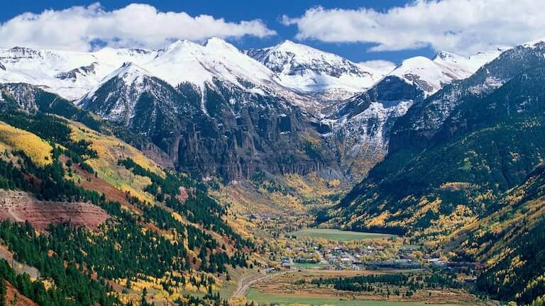 Wide view of the Telluride valley with the San Juan Mountains in the distance