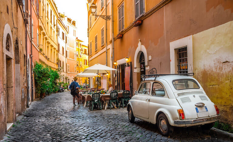 A quaint, cafe-lined street in Europe.