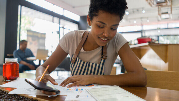 A young business owner doing the books at a cafe