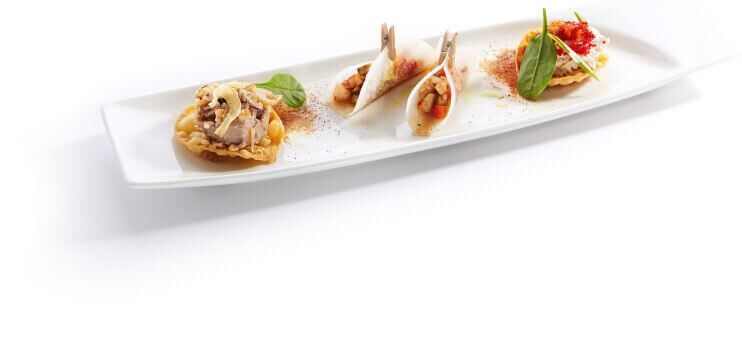 Three gourmet appetizers on a white serving plate