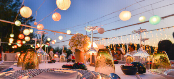 An elaborate outdoor table setting for a wedding reception