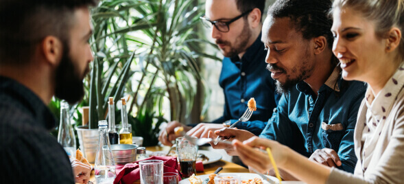 A group of diners enjoy a meal in a restaurant