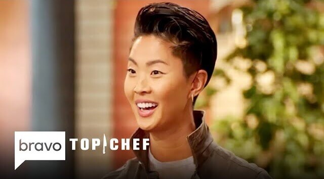 Bravo's Top Chef Host Kristen Kish looking at the camera sideways