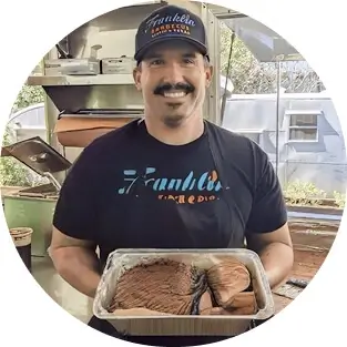 Michael Fields holding a tray of meat at Franklin BBQ
