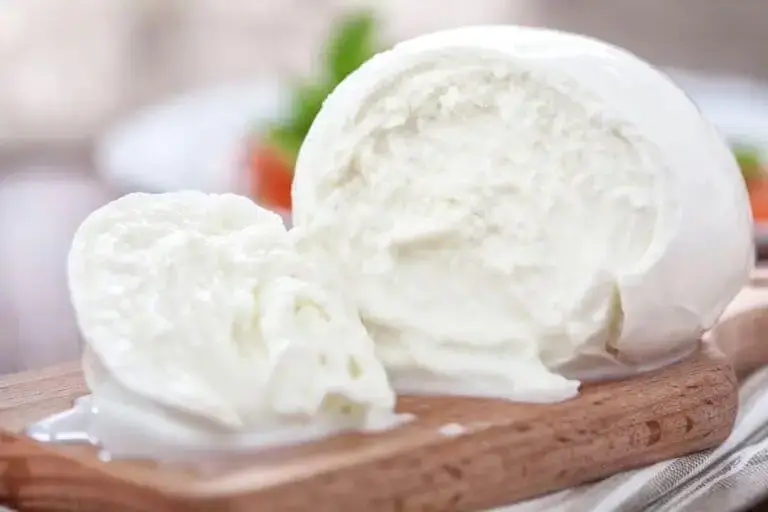 Closeup of a ball of watery buffalo mozzarella that has been sliced.
