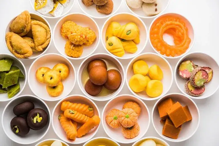 An assortment of colorful marzipan sweets displayed in small bowls.