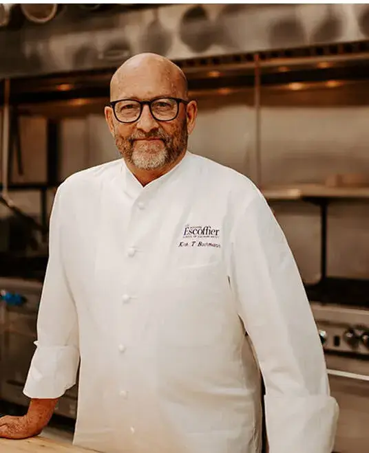 Headshot of Kirk. T. Bachmann standing in the kitchen