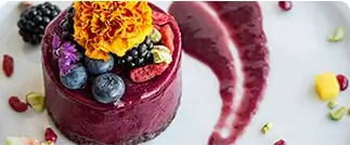 Chocolate cake topped with chestnuts and powdered sugar on wooden surface