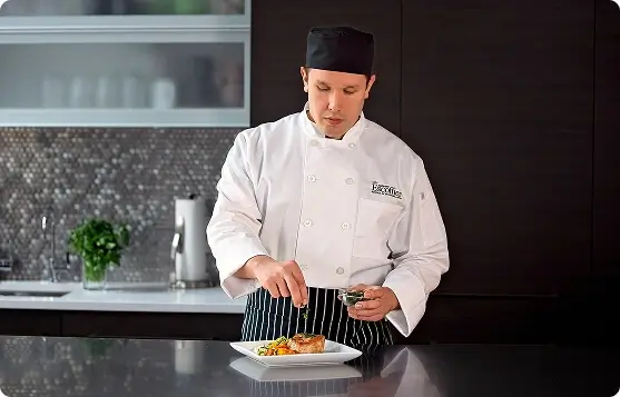 Blueberry chocolate tart with berry coulis splatter on a white plate