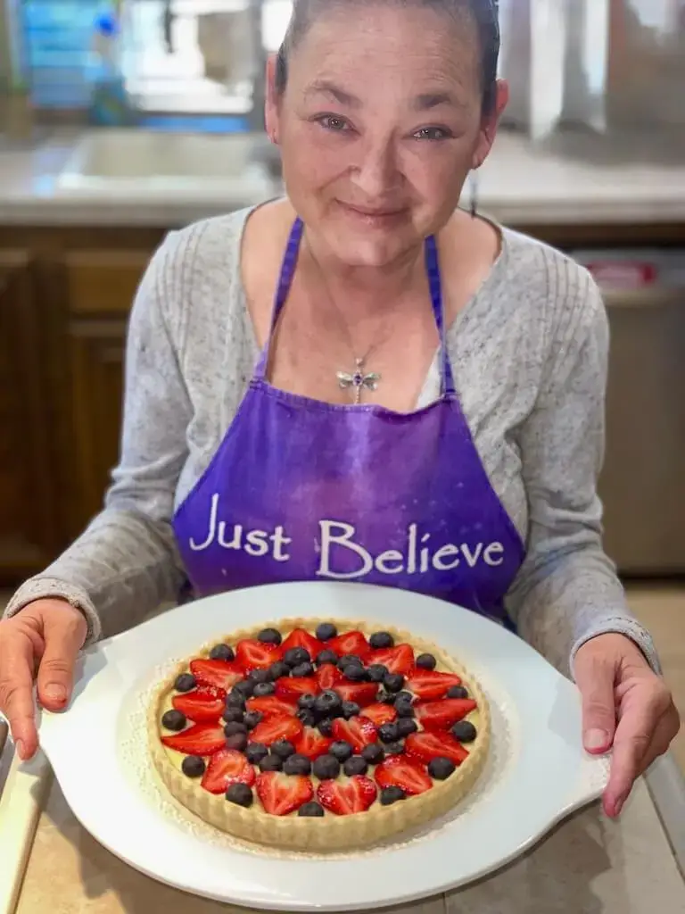 Daniela Peregrina wears the purple “Believe” apron a stranger gifted her, encouraging her to believe in her dreams.