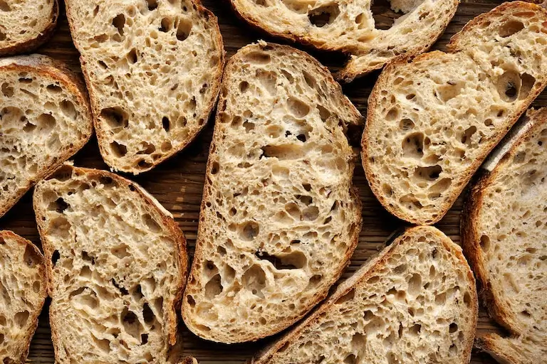 Slices of sourdough bread showing open crumb structure.