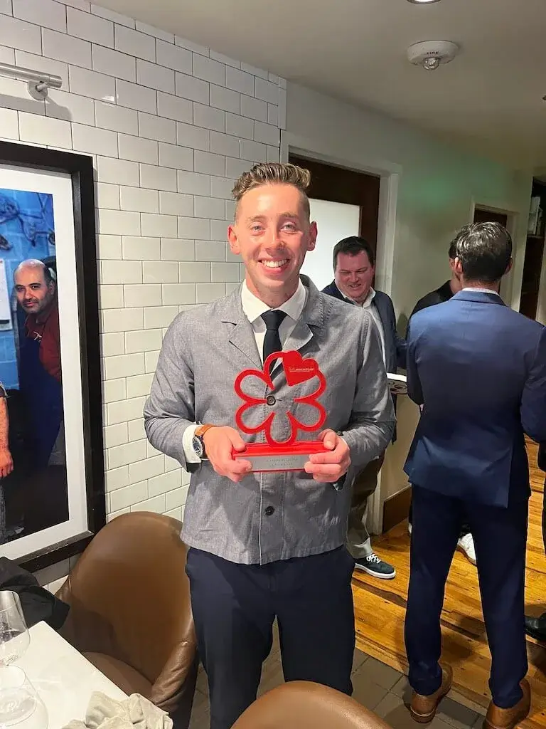 Connor Fowler holding the 2023 Michelin Colorado Service Award