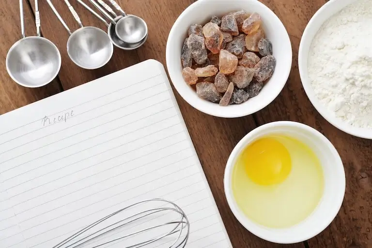 Handwritten recipe book listing ingredients and quantities.