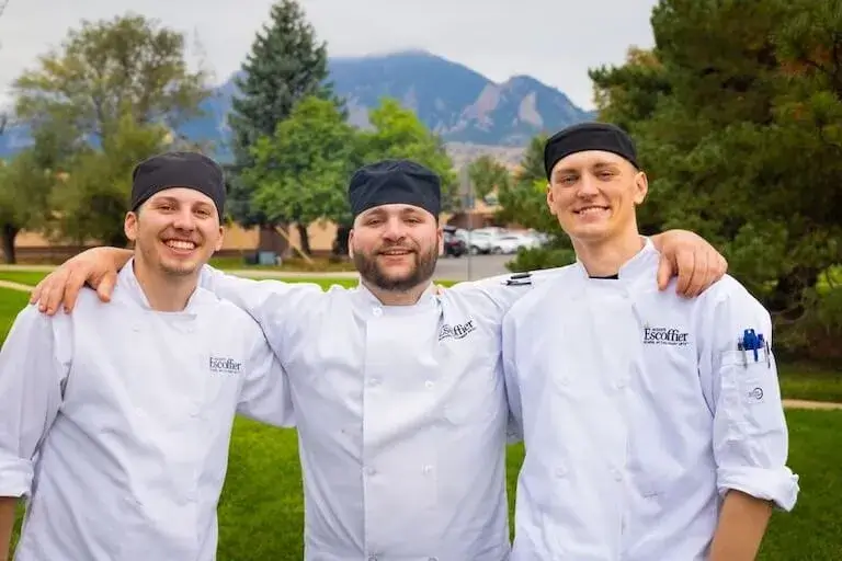 Escoffier culinary students at Boulder campus with Rocky Mountains in background.