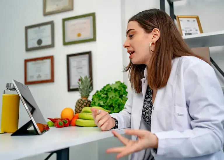 Nutritionist consulting with tablet and fresh foods