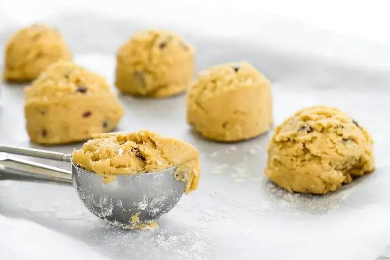 Scooped cookie dough on a tray