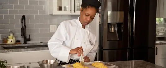 escoffier online culinary student basting_challah in home kitchen