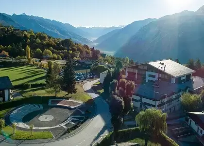Aerial view of Les Roches Switzerland campus surrounded by alpine mountains and autumn foliage in Bluche, Switzerland