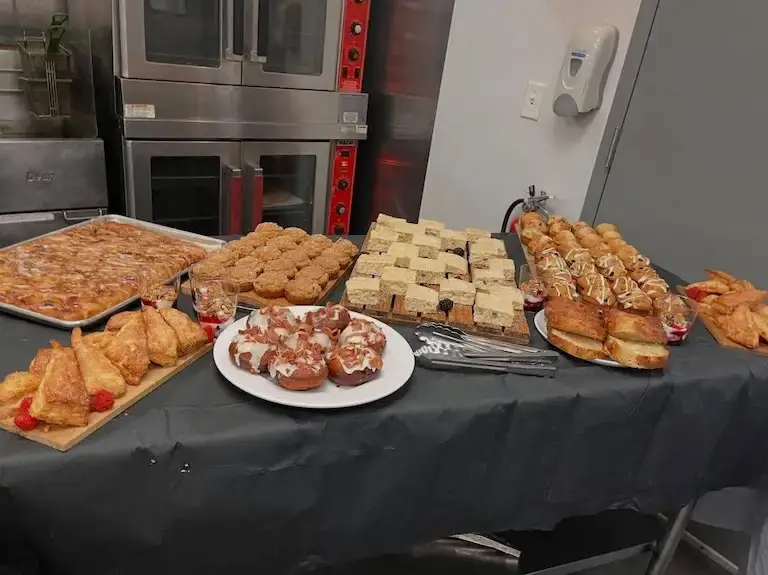 Assorted pastries and baked goods arranged on a table for an event presented by Escoffier Austin campus students.