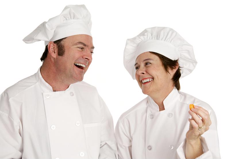 Two chefs smiling at each other