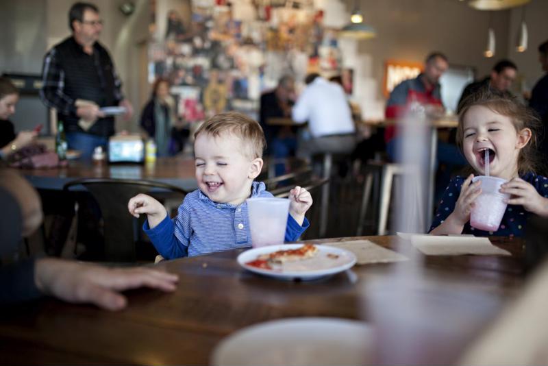 Child eating dinner at restaurant.