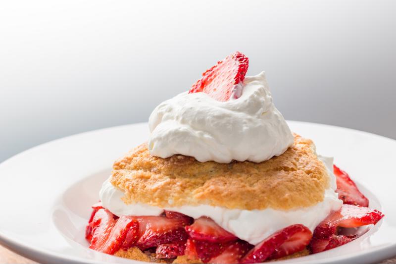 A strawberry shortcake served on a plate.