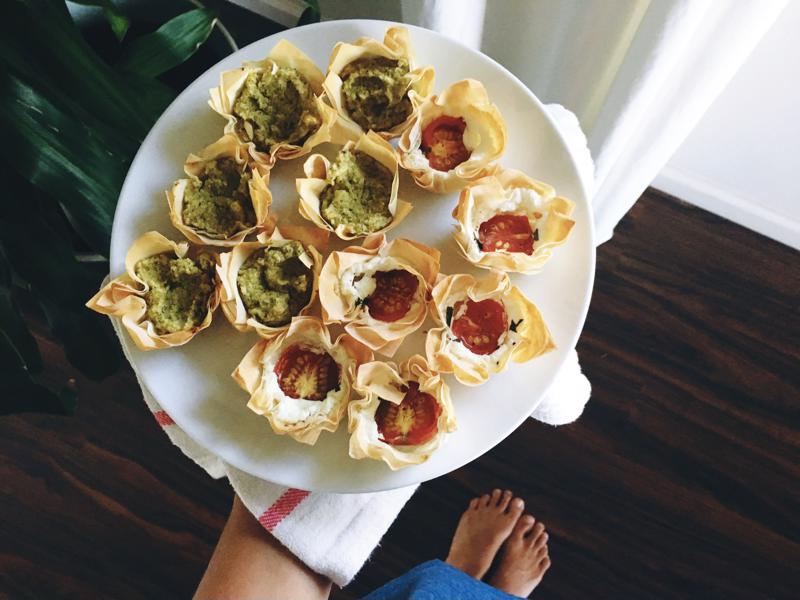 A tray of appetizers in dough cups.