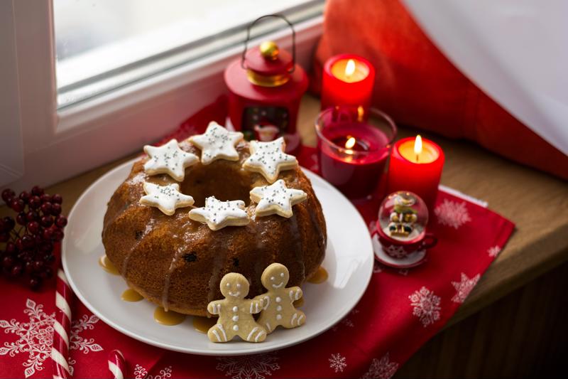 A Bundt cake with sugar cookies on and around it, shown as part of a holiday table display.