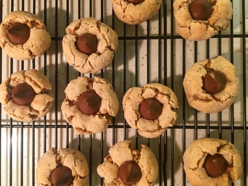 An overhead shot of a tray of blossom cookies cooling on a wire rack.