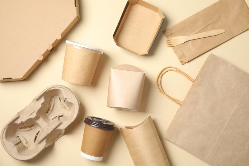 A variety of paper containers lying on a neutral background.