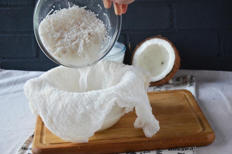 A chef making coconut milk.