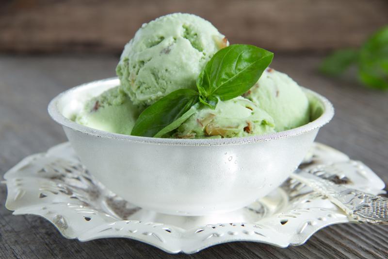 A bowl of mint-nut ice cream sitting on a table.