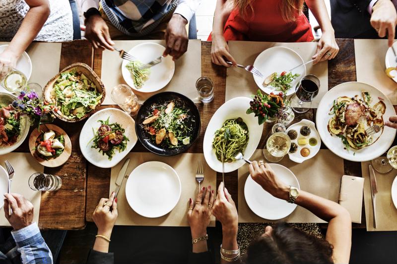 An overhead shot of customers eating a family-style meal.