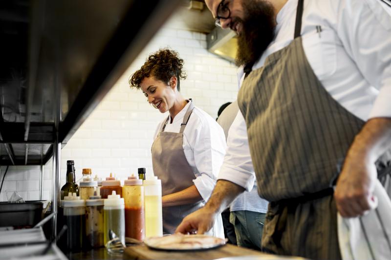Two chefs working together in the kitchen.