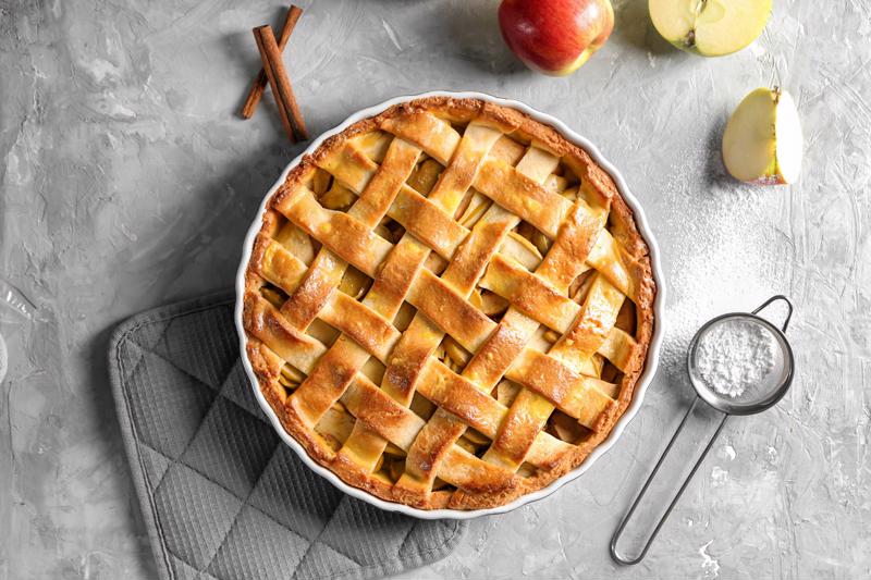 A pie with a lattice crust on a table.